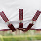 triple surcingle detail shown of white horse rug with red trim, by leader equine