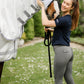 woman in equestrian breeches by leader equine 