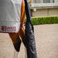 Close up showing hind end of horse from the side wearing grey cooler rug by leader equine and navy travel tail wrap with tail bag