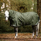 Horse wearing a green leader equine boxter turnout rug in a forest setting