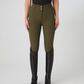 A model wearing ps of sweden olive green equestrian riding breeches with black suede knee panels and black riding boots, shown from the waist down against a light gray studio background.