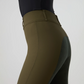 Close-up side view of a person wearing ps of sweden high-waisted riding tights in olive green with dark green suede seat panels