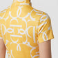 A close-up back view of a model wearing a yellow short-sleeve top with a bold white abstract geometric pattern.