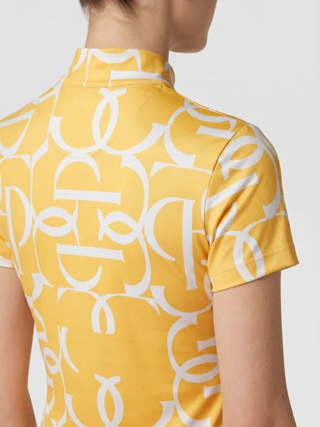 A close-up back view of a model wearing a yellow short-sleeve top with a bold white abstract geometric pattern.